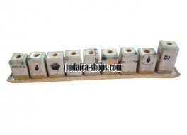 Cream ceramic Menorah with pictures and words about Hanukah.
